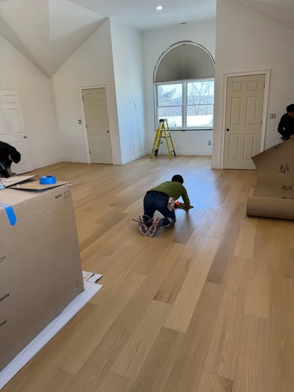 Light oak floor going in under an arched window
