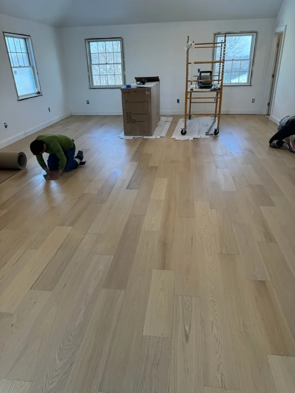 Crew laying a light oak floor