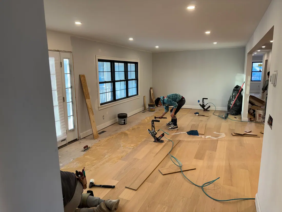 Crew nailing down a new hardwood floor
