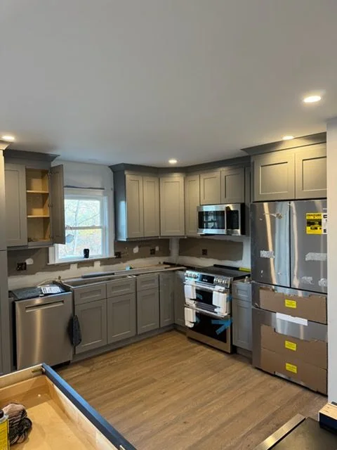 Gray shaker kitchen and stainless appliances on the same Mahopac remodel
