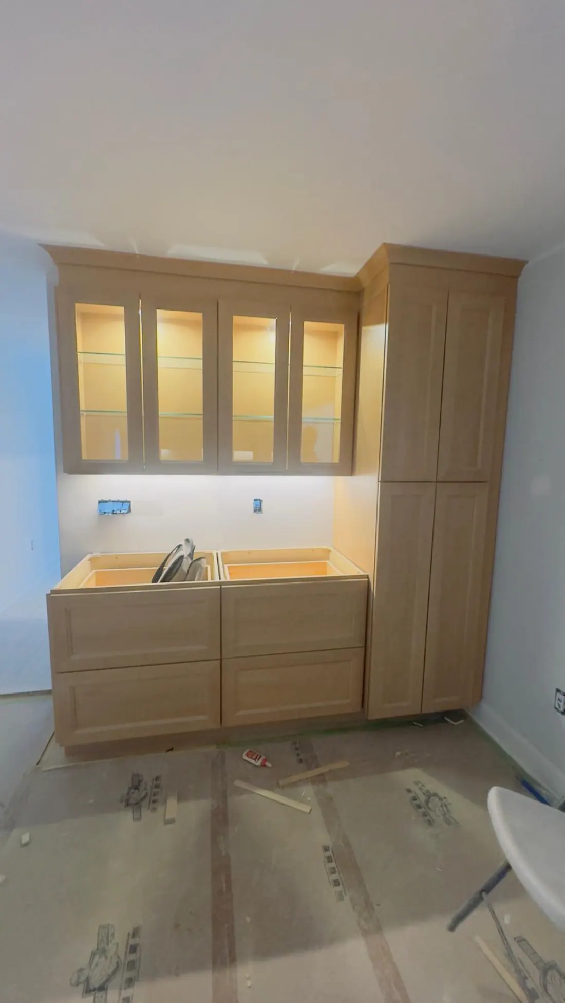 Glass-front built-in with lit shelves