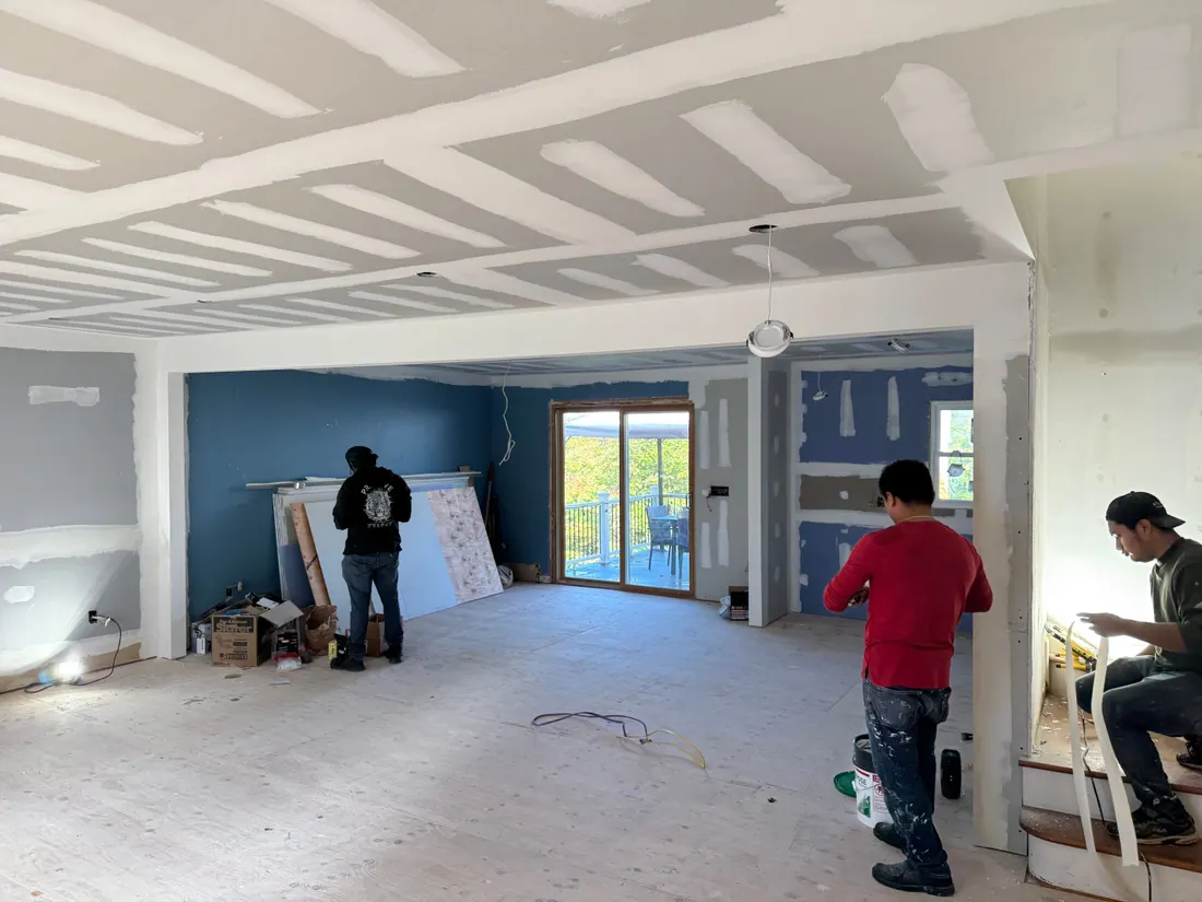 Drywall finishing across an open first floor