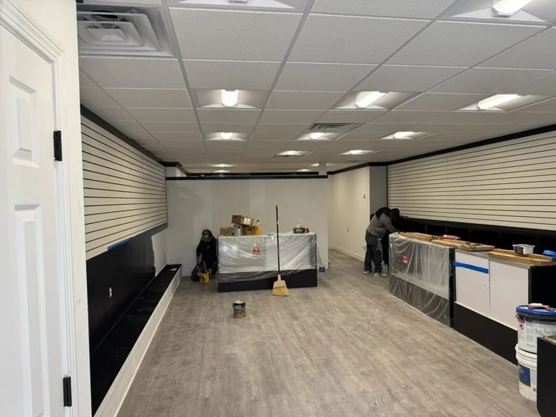 Crew finishing slatwall and counters in a retail store