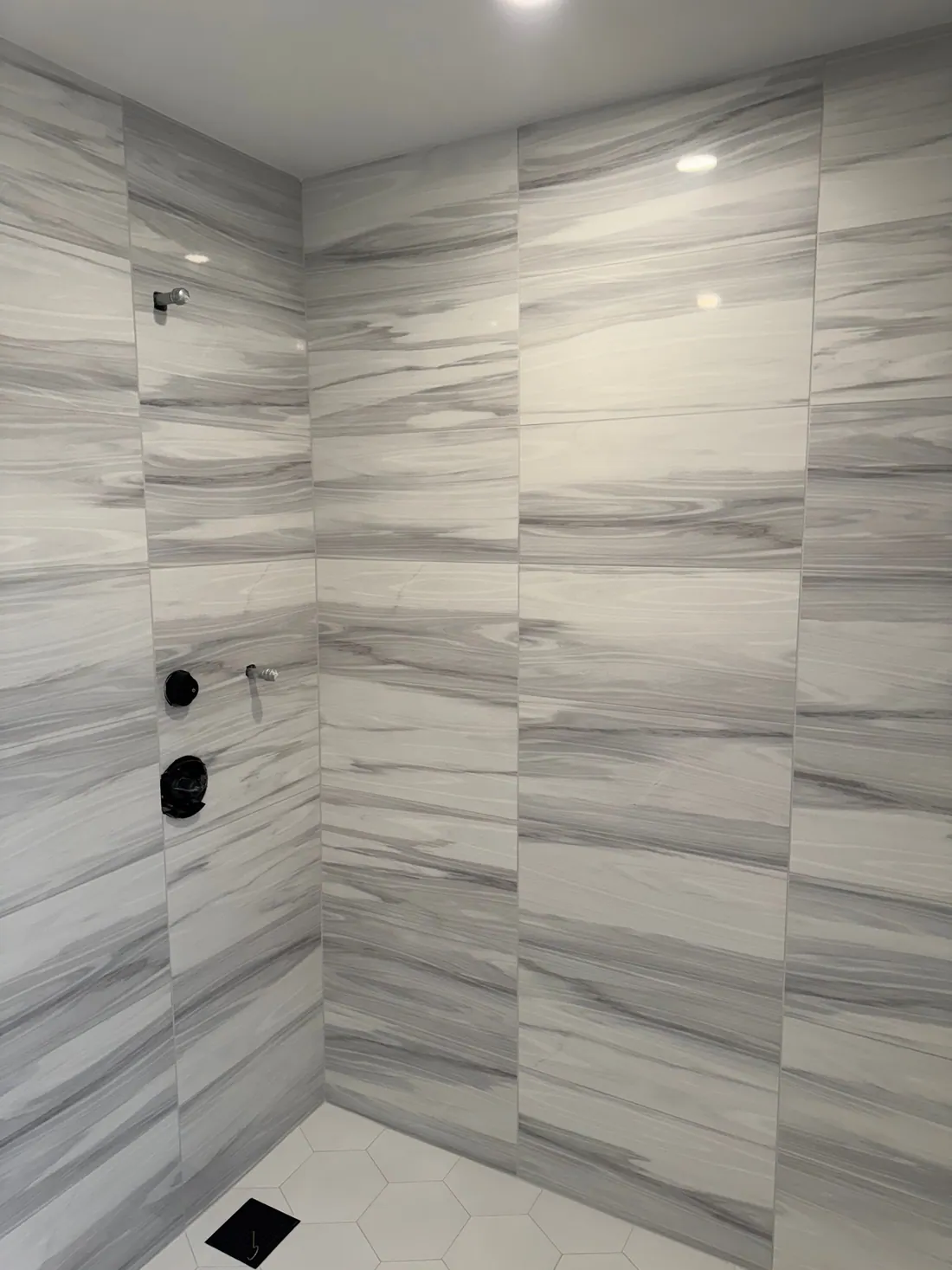 Large-format tile with matte black valves